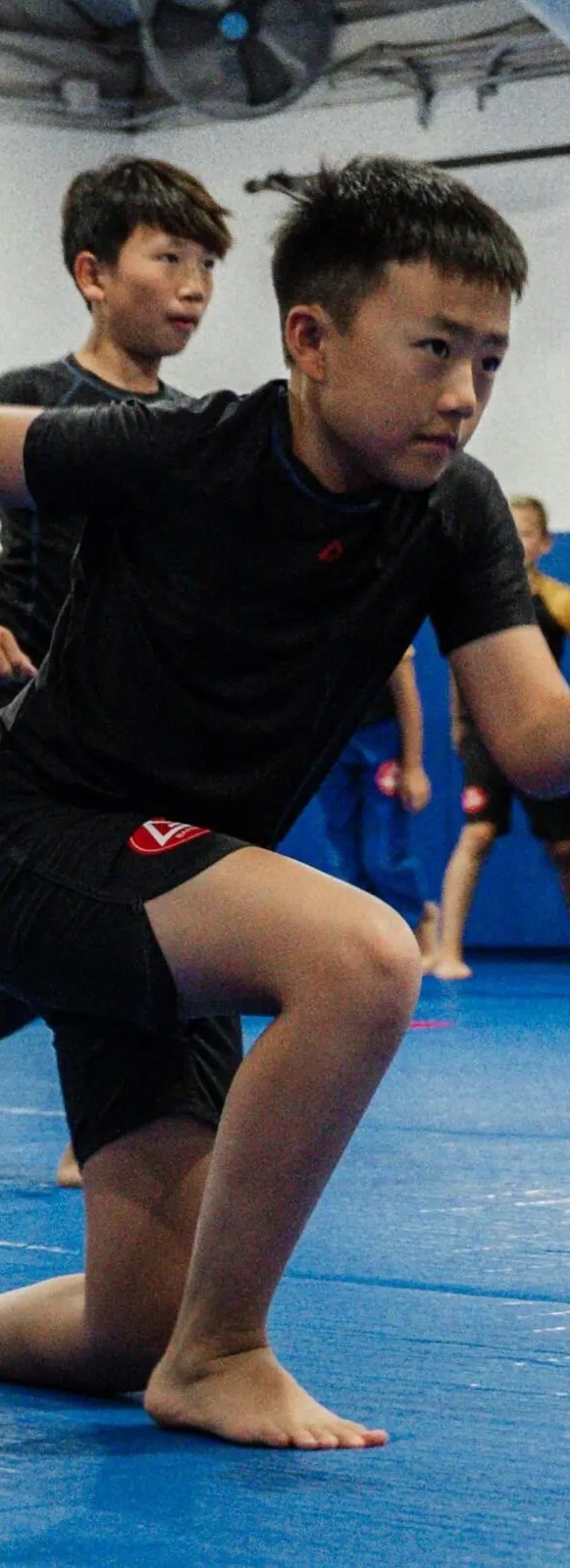 Adult students training Brazilian Jiu-Jitsu at Gracie Barra Newton